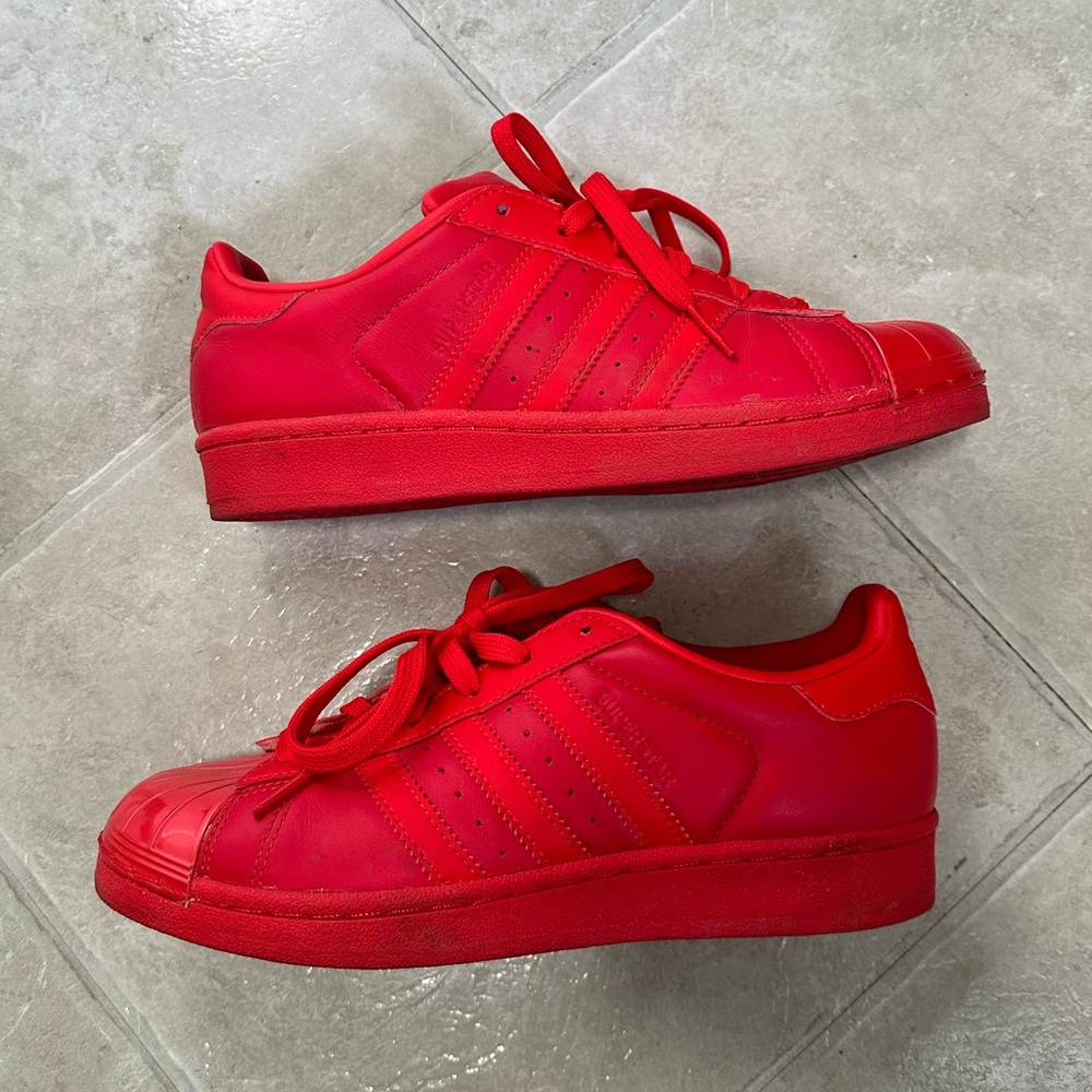 Bright Red Adidas Superstar shoes.